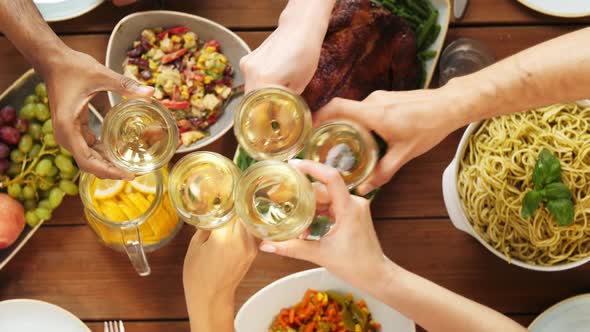 People Clinking Wine Glasses at Table with Food 24