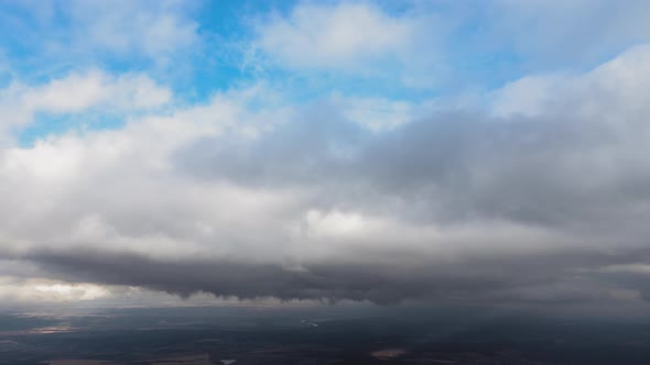 Aerial View From High Altitude of Earth Covered with Puffy Rainy Clouds Forming Before Rainstorm