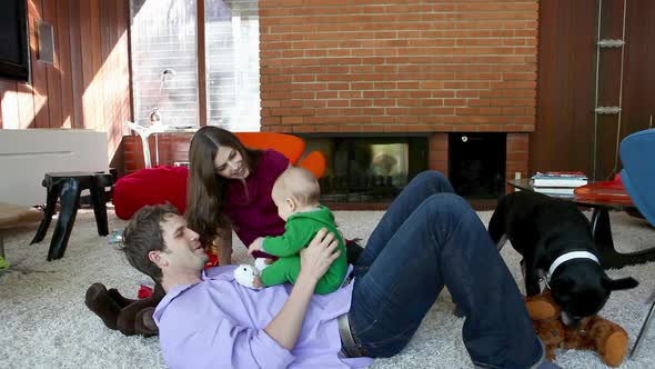 Parents playing with baby son in living room