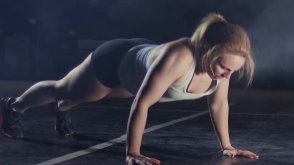 Strong Confident Fitness Woman in Sport Shorts Is Doing Push Up Workout