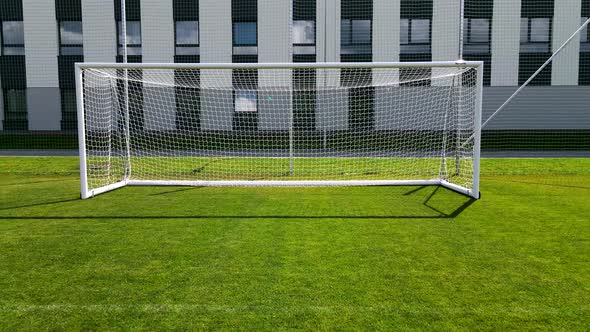 the Drone Flies Across the Football Field and Flies Into the Goal