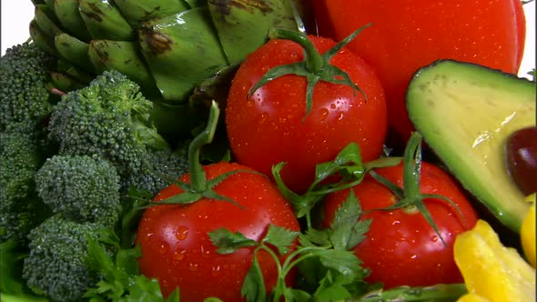 Assortment of vegetables rotating on a white screen.