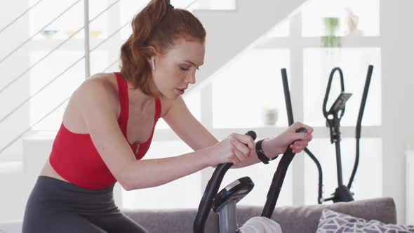 Woman exercising on stationary bike at home