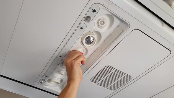 Girl Adjusts The Air Flow In The Plane