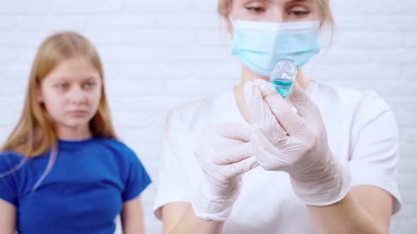 Nurse Preparing Syringe with Medicine for Injection