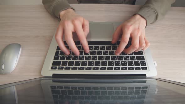 Close Up Man Is Working on a Laptop Computer at Home