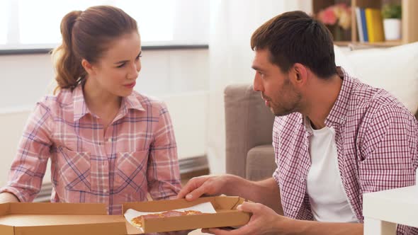 Couple Eating Takeaway Pizza at Home