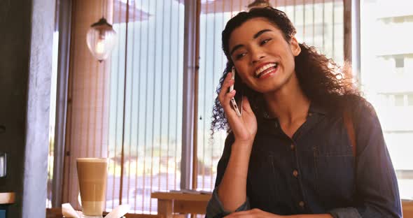 Smiling woman talking on mobile phone