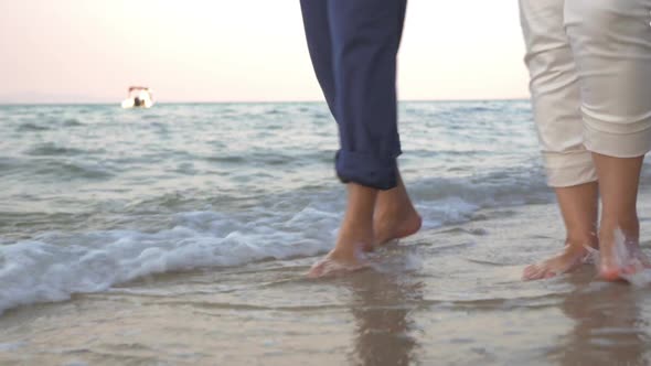 Couple Walking in Incoming Sea Waves