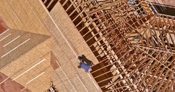 Roofer Working on a New Roof in Wood