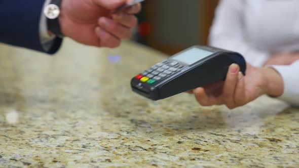 Traveler at hotel reception. Customer paying for services in hotel