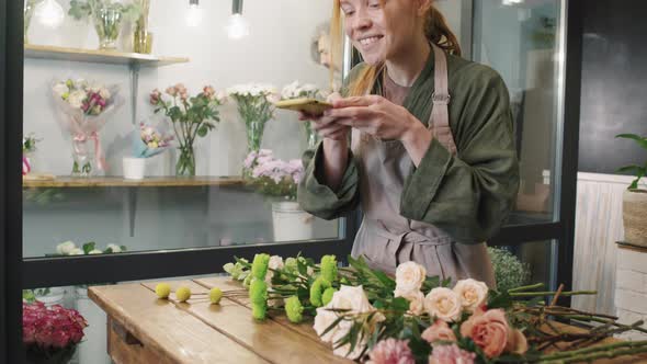 Beautiful Florist Taking Photos Of Flowers