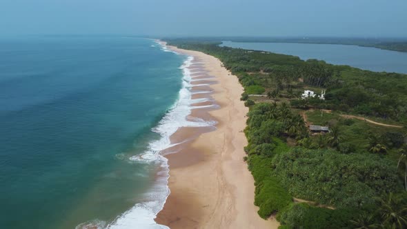 Deserted beach and ocean coast with waves. Wild sandy beach.