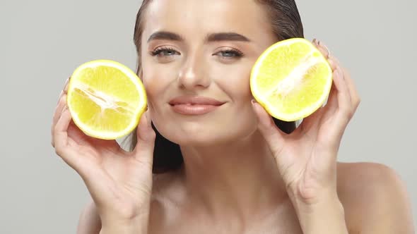 Joyful Girl with Perfect Skin Playing with Fresh Fruits