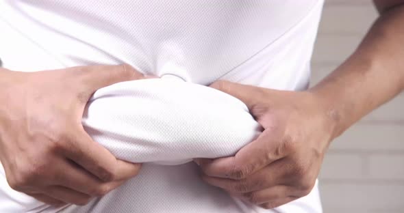 Man's Hand Holding Excessive Belly Fat Overweight Concept