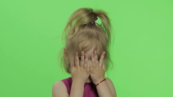 Child Portrait in Purple Dress. Hides Her Face with Hands and Sculps. Chroma Key