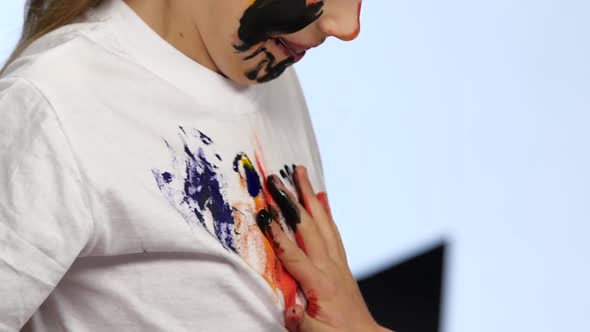 Two Little Girls Draw Their Palms on the Shirt. White Background. Slow Motion