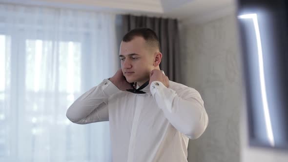 Groom Adjusts Bow Tie. Preparing To Go To the Bride. Businessman. Wedding Day