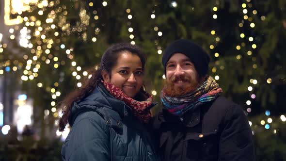 Happy Mixed Young Couple Dating in Winter Outside at Christmas