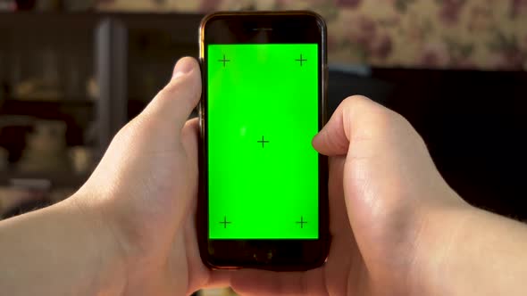 The Man Uses the Phone. Hand Makes Swipe Right on Smartphone with Green Screen. Chroma Key.