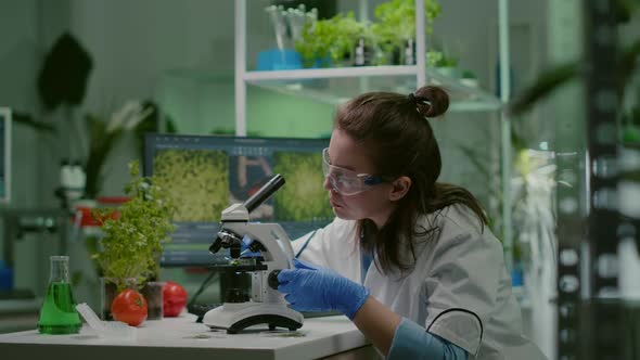 Biologist Taking Leaf Sample Putting Into Microscope