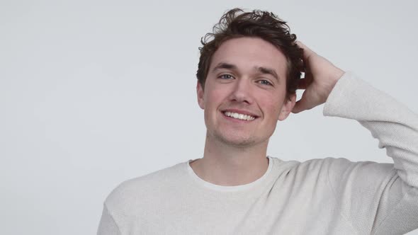 Smiling Model while Brushing His Hair with Hand