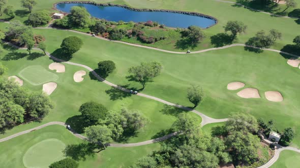 Aerial Footage of People on Green Golf Course Playing Sport Game Hawaii Maui USA