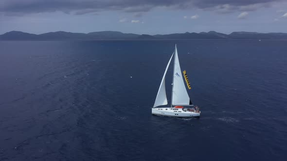 Yacht Sailing at Sunset During a Storm