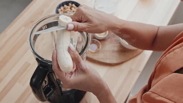 Close Up of Woman Making Smoothie with Banana