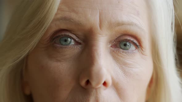 The Face and Eyes of the Old Woman. Large Wrinkles on the Old Woman's Face. Face Close Up