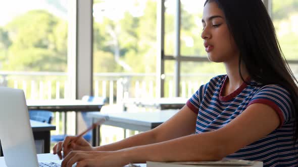 Student using laptop in classroom