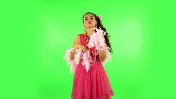 Girl Dancing, Seductively Smiling and Posing with Pink Feathers. Green Screen
