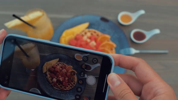 Female Hands Photographing Appetizing Food By Smartphone in the Restaurant