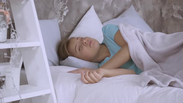 Beautiful Caucasian Woman Lying on Pillow on Bed