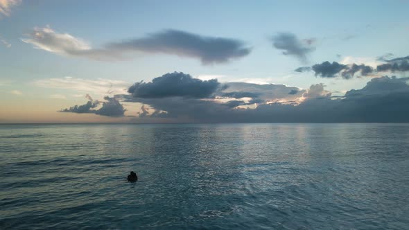 Couple In Love Swims On The Sea Before Sunset