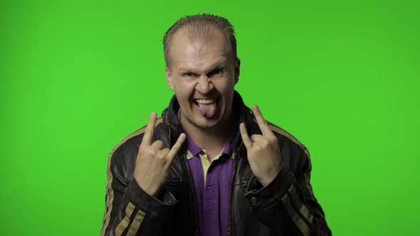 Rocker Man Showing Rock and Roll Sign, Devil Horns Gesture, Looking with Crazy Expression