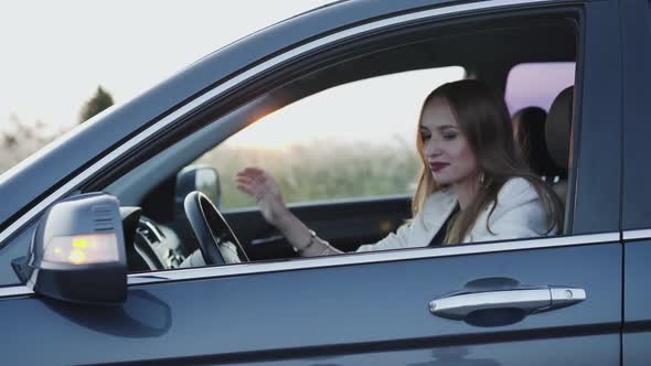 Happy Lady in Car Turns to Camera Leans on Doors and Smiles