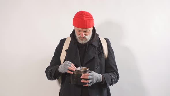 Portrait of Homeless Beggar with Cup for Money, Finds Paper Money in His Cup