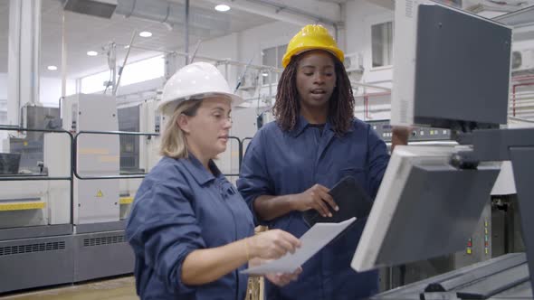 Black Female Industrial Expert Presenting Machine