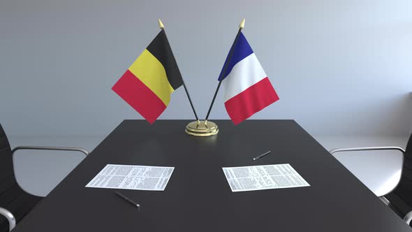 Flags of Belgium and France and Papers on the Table