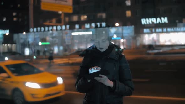 Woman with Digital Tablet in Night City