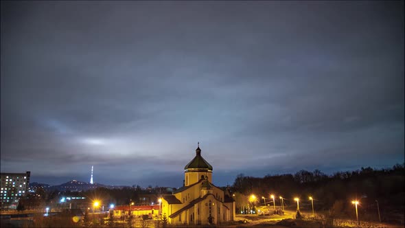 Beautiful time lapse: massive clouds floating night city sky.