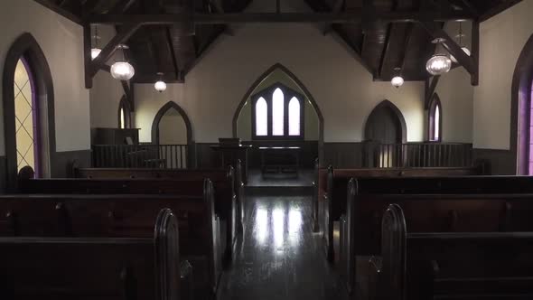 Interior of a rustic church and pews.