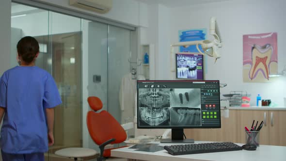 Nurse Typing on Computer with Digital Xray