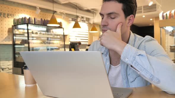 Thinking Brainstorming Young Man Working in Cafe