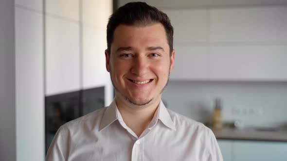 Portrait of cheerful happy man looking at camera and smiling. Close up shot