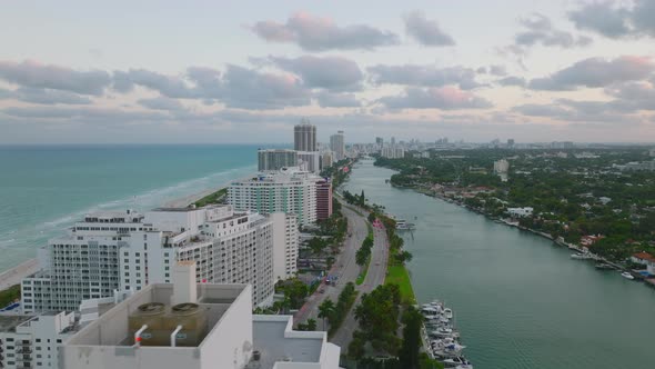 Forwards Fly Above Multistorey Apartment Buildings at Sea Coast and Multilane Road Leading on