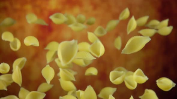 Pasta Conchiglie is Bouncing on a Yellow Ochre Background