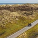 Man and woman riding bikes on dirt road, Nes, Friesland, Netherlands - VideoHive Item for Sale