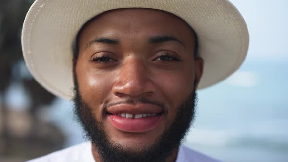 Headshot Portrait of Handsome Smiling African American Gay Man Looking at Camera Standing Outdoors